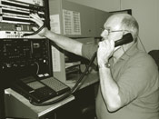 A Reporting Service employee monitors the audio recording of proceedings. 