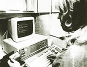 A reporting secretary transcribes from audio cassette.