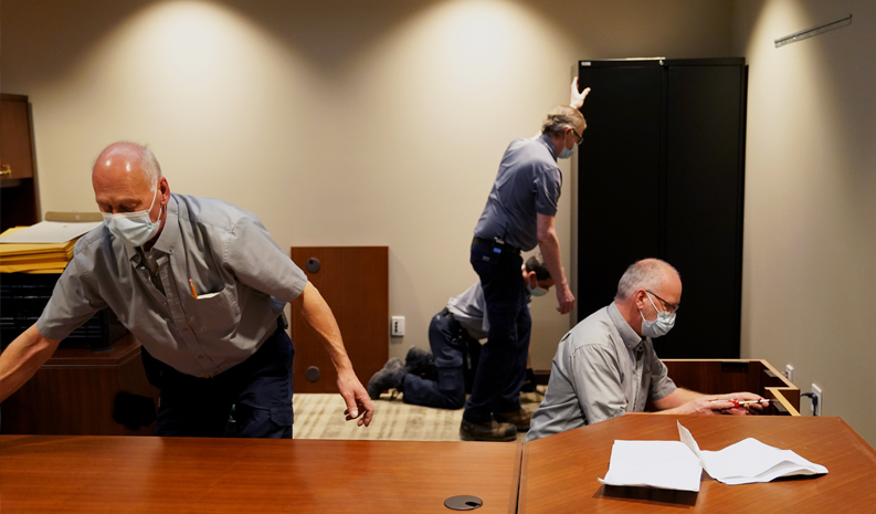 Employees of the Administration move furniture in a Member's office