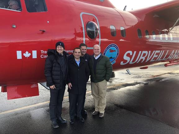 Figure 15 is a photo of some Members of the Foreign Affairs Committee standing outside a red Dash-7 aircraft maintained by Transport Canada as part of the National Aerial Surveillance Program. The photo was taken on the tarmac of the Iqaluit airport.
