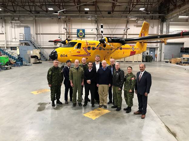 Figure 19 is a photo of Members of the Foreign Affairs Committee with members of the Canadian Armed Forces’ Joint Task Force North within the air hangar of the 440 Transport Squadron in Yellowknife.