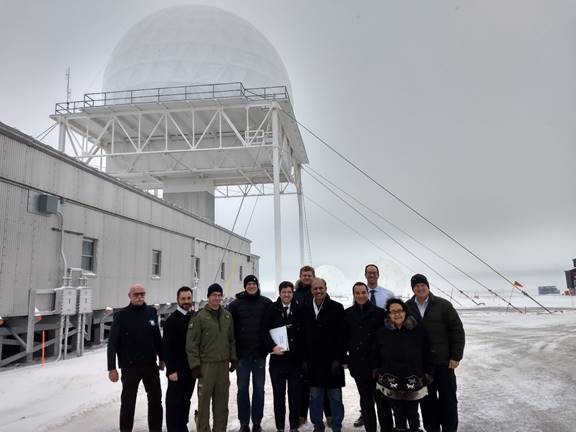 Figure 20 is a photo of Members of the Foreign Affairs Committee standing outside the site of the North Warning System in Cambridge Bay.