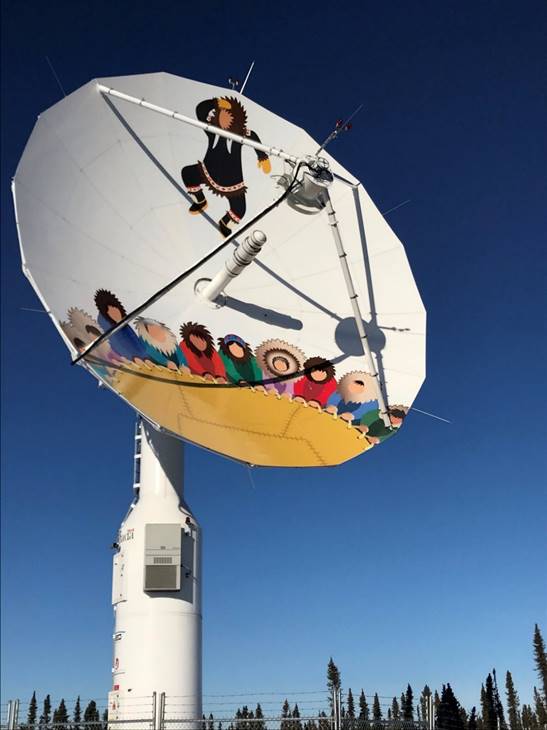 Figure 22 is a photo of a satellite receiving dish that is part of the Inuvik Satellite Station Facility in Inuvik. There is artwork painted on the satellite dish.