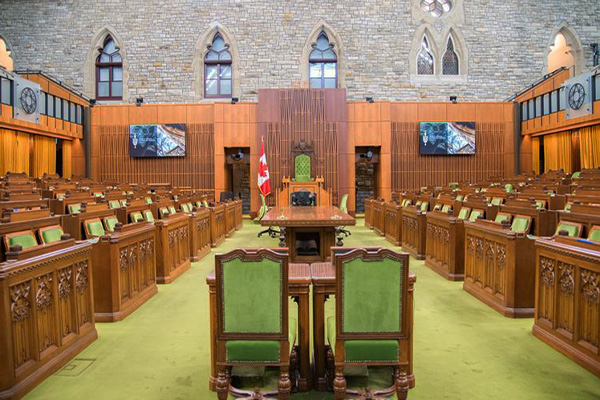 A view of the empty House of Commons from the floor, looking toward the Speaker’s chair