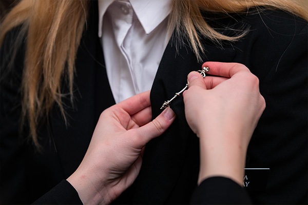 A Page in the House of Commons receives a pin